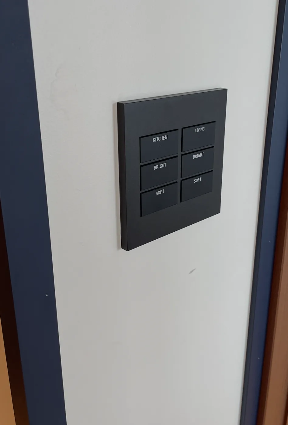 A wall keypad labeled Kitchen and Living with Bright and Soft scene buttons